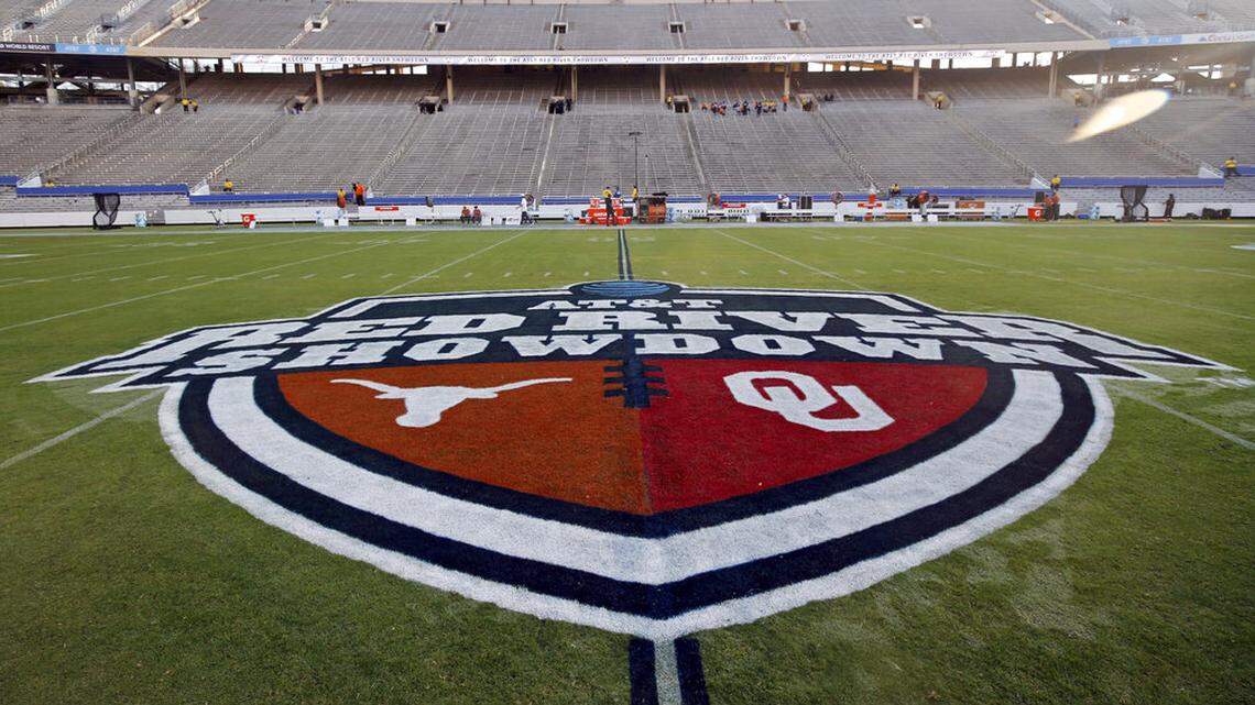 FILE - In this Oct. 10, 2020, file photo, The Red River Showdown logo is displayed on the field of the Cotton Bowl, prior to an NCAA college football game between the University of Texas and Oklahoma, in Dallas. Texas and Oklahoma made a request Tuesday, July 27, 2021, to join the Southeastern Conference — in 2025 —- with SEC Commissioner Greg Sankey saying the league would consider it in the “near future.” (AP Photo/Michael Ainsworth, File)