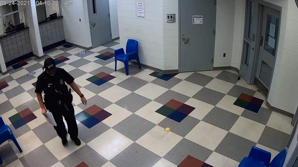 A screenshot of a video taken on Sept. 24, 2021at JIAC. It shows Wichita police officer Ryan O’Hare leaving to confer with other officers after filling out the officer release form. When he returned he changed his answers on the form.