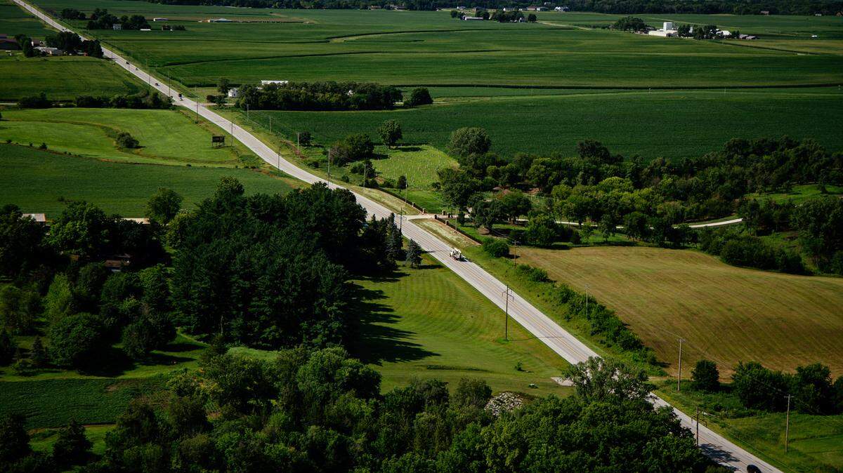 Fields of corn and soybeans grow next to a county road in central Iowa. Aerial support provided by LightHawk.