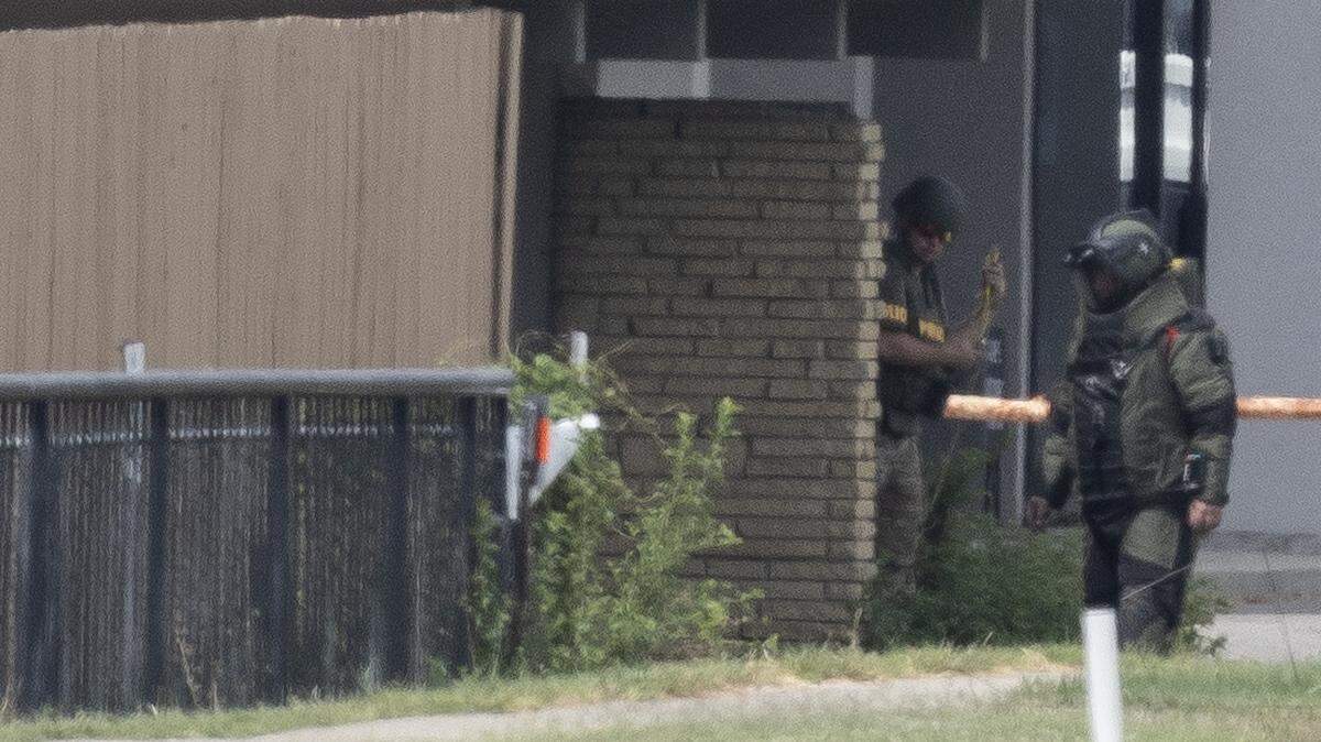 Bomb squad members work around the north side of the Trust Women clinic between Oliver and Edgemoor on Wednesday afternoon. A suspicious package at the clinic resulted in the total shutdown of Kellogg during the morning commute out of an abundance of caution while law enforcement investigated the scene.