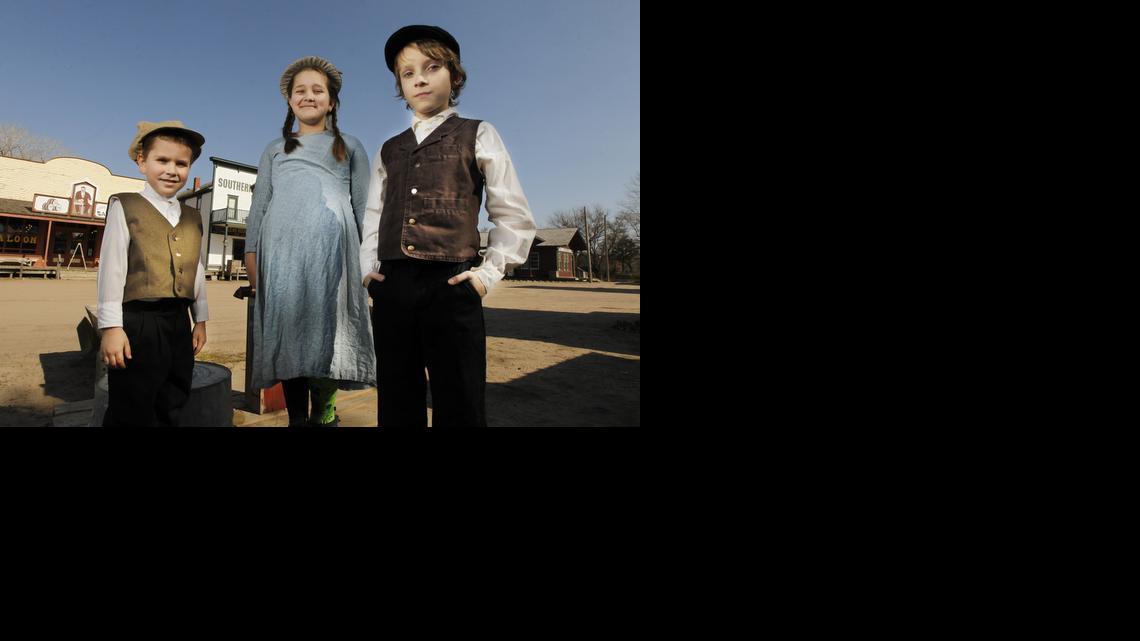 Connor West, 9, right, and his siblings Caity, 12, center, and Cole, 5, are volunteers at Old Cowtown Museum. 

