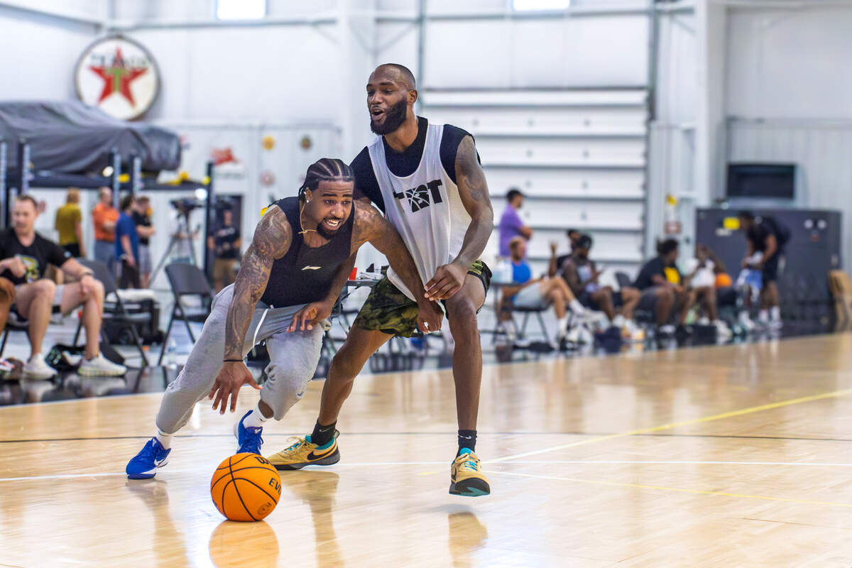 Marcus Keane drives against Markis McDuffie in a recent AfterShocks practice in Wichita.