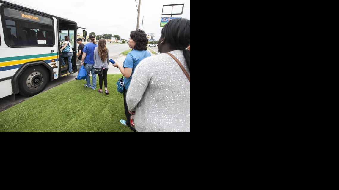 Passengers board a bus on East Harry on a free-ride day. (July 17, 2014)

