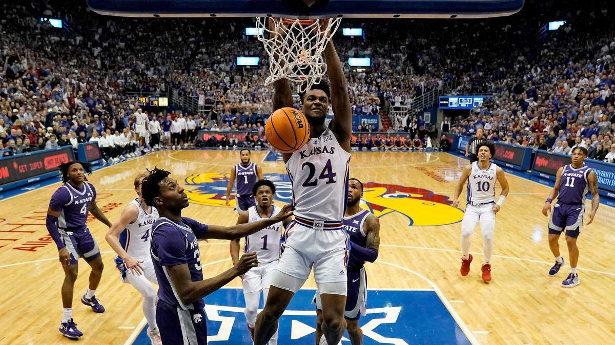 Kansas forward K.J. Adams Jr. dunks the ball amidst the K-State defense during the first half on Tuesday, Jan. 31, 2023, at Allen Fieldhouse in Lawrence, Kan.
