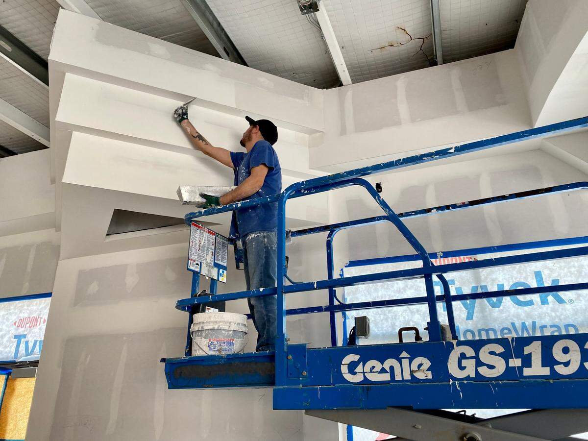 A construction worker finishes dry wall work inside the soon-to-open Itzcali Tapas & Tequila on East Central. The owner says the project has taken so long to finish because he wants it to be just right.