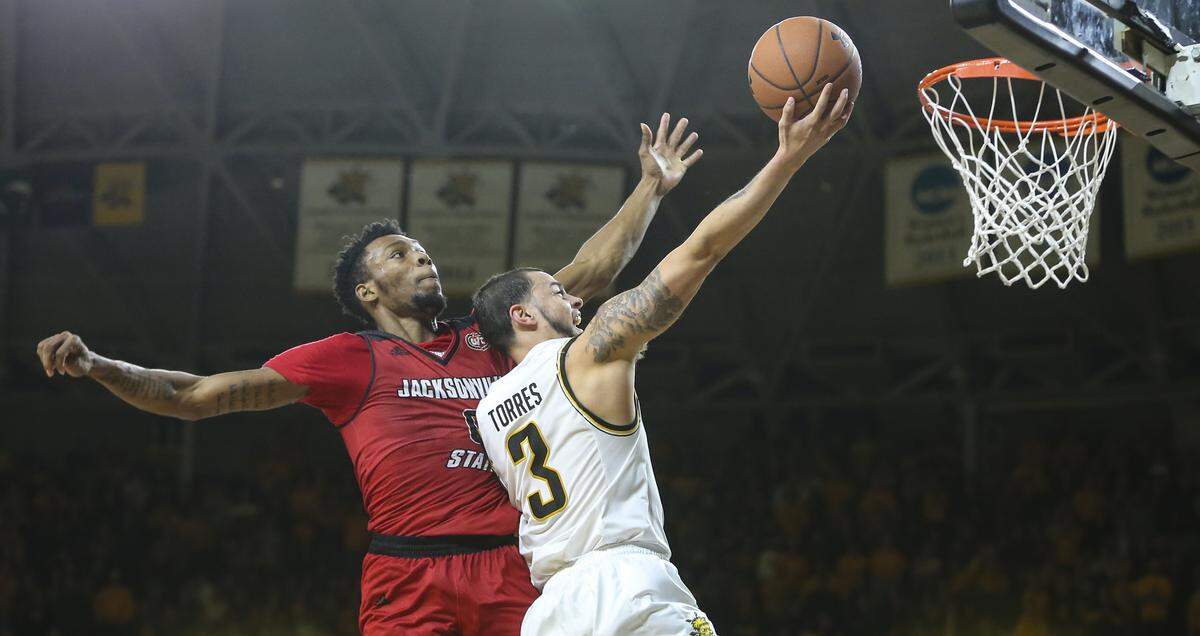 Wichita State guard Ricky Torres hits a shot against Jacksonville State guard Jamall Gregory during the second half of their game at Koch Arena on Wednesday.