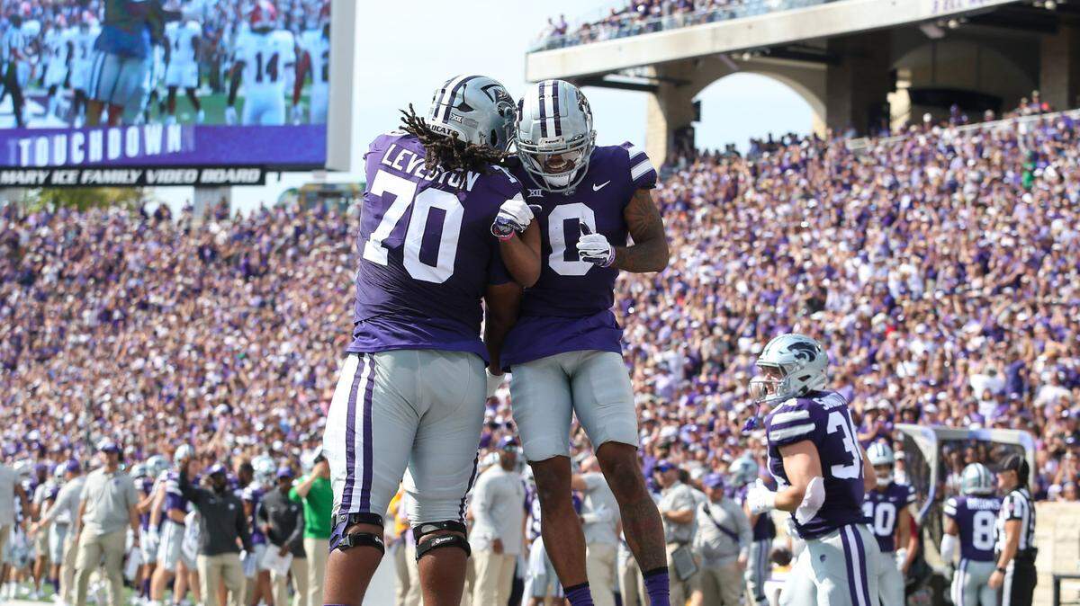 Kansas State Wildcats wide receiver Jadon Jackson (0) and offensive lineman KT Leveston (70) celebrated a touchdown in the first quarter against the Troy Trojans at Bill Snyder Family Football Stadium.