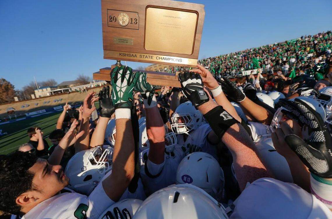 Derby players hold up the 2013 Class 6A championship trophy. Eight football champions will be crowned in Kansas in November.