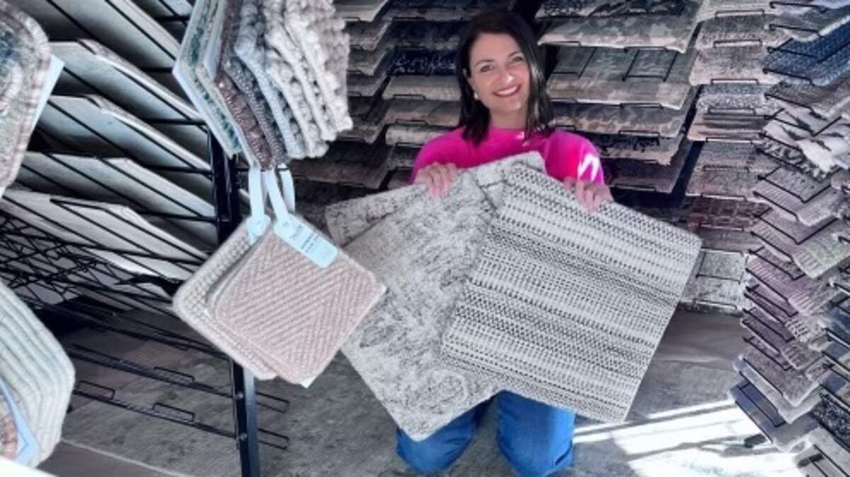Philip Holmes’ Rug Studio is reopening within Rachel Thomas-Murphy’s Thomas Grey Interiors downtown. Thomas-Murphy is pictured with some rug samples.