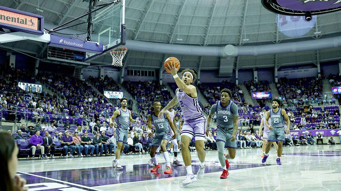 Kansas State basketball player Max Jones grabs a loose ball against the TCU Horned Frogs