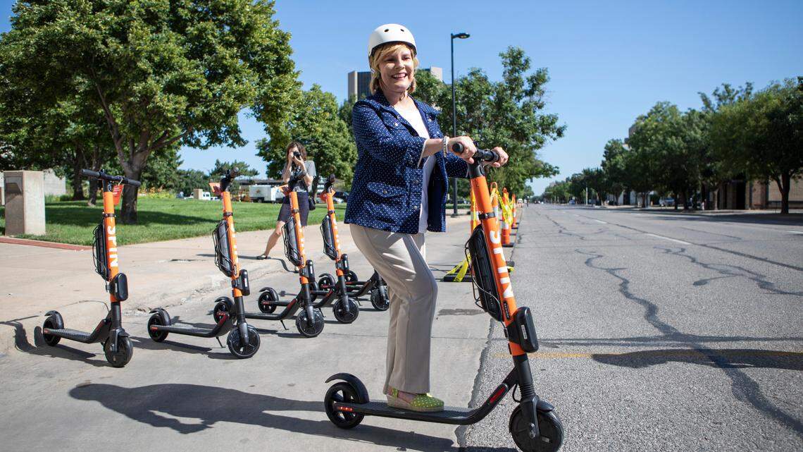 Wichita City Council member Becky Tuttle rides an electric scooter on Main Street in 2019.