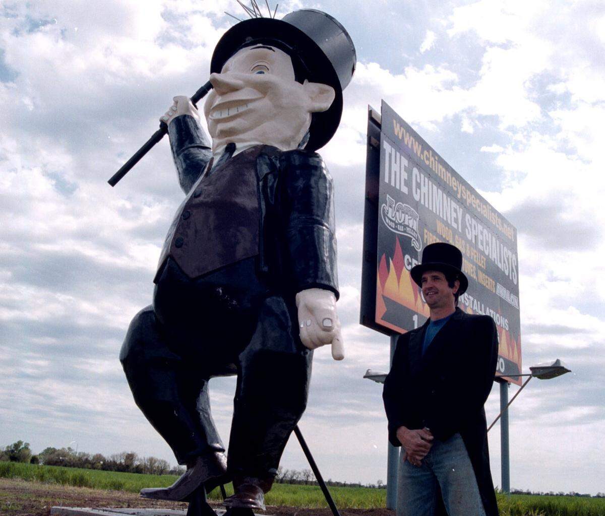 Vaughn Juhnke is pictured in 2000 when he posted the remodeled statue near his billboard on I-135.