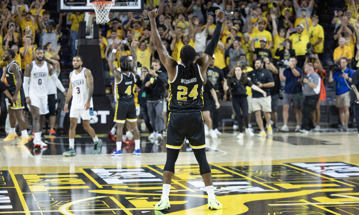James Woodard celebrates after Marcus Keene sealed the win with a free throw against Eberlein Drive on Sunday at Koch Arena.