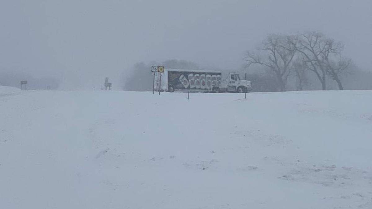 A jackknifed semi blocks the intersection of U.S. 35 and K-14 south in Jewell County Monday afternoon. The highway had become covered in snow hours earlier. The National Weather Service reported 9 inches of snow had fallen in the town of Jewell by 1:45 p.m. (Jan. 25, 2021)