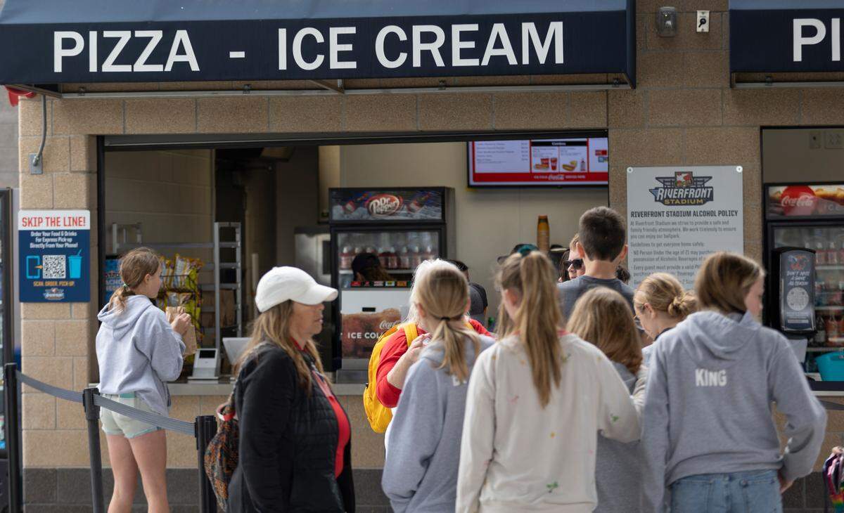 People line up at a concession area at Riverfront Stadium during a recent Wichita Wind Surge game.