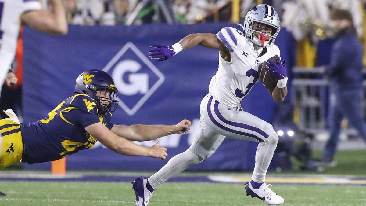Kansas State Wildcats running back Dylan Edwards (3) returns a punt during the third quarter against the West Virginia Mountaineers at Mountaineer Field at Milan Puskar Stadium.