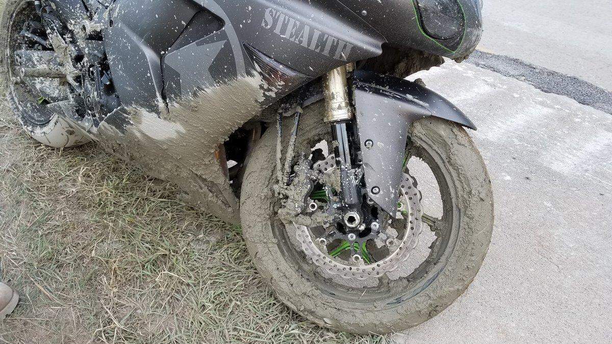 The Michigan Department of Transportation said a driver left his motorcycle in wet concrete after it got stuck in a work zone.