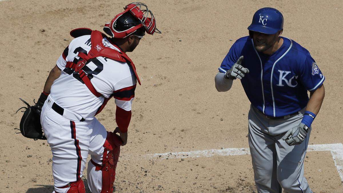 Kansas City Royals’ Alex Gordon, right, touches the plate after hitting a solo home run as Chicago White Sox catcher Omar Narvaez looks on during the second inning Sunday in Chicago. It was Gordon’s 169th homer as a Royal, tying him with Hal McRae for fourth on the club’s career home runs list.