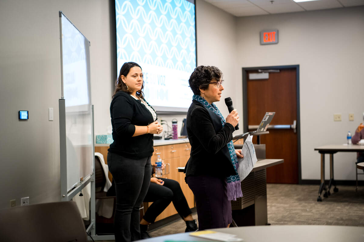 Rachel Showstack, right, founder of Alce Su Voz, speaks during an event about health equity for Spanish speakers and speakers of indigenious languages.
