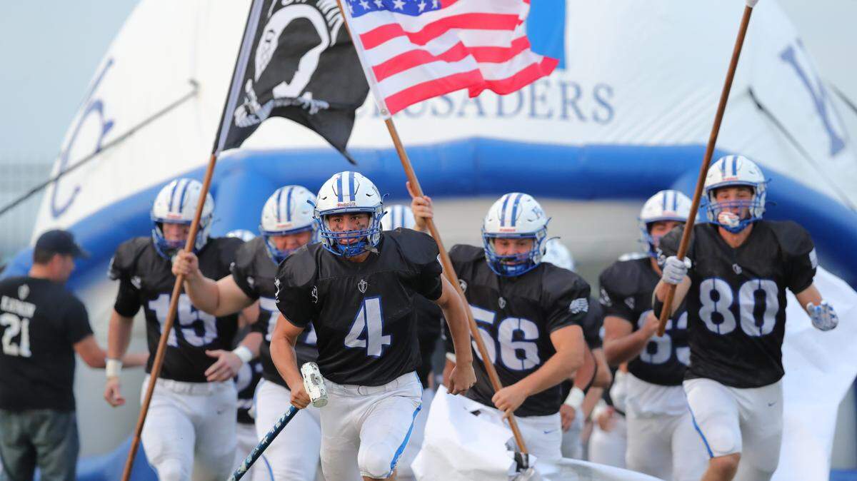The Kapaun Mt. Carmel football team honored the return of Father Kapaun with black uniforms that included POW patches for their 42-7 win over Great Bend on Friday.