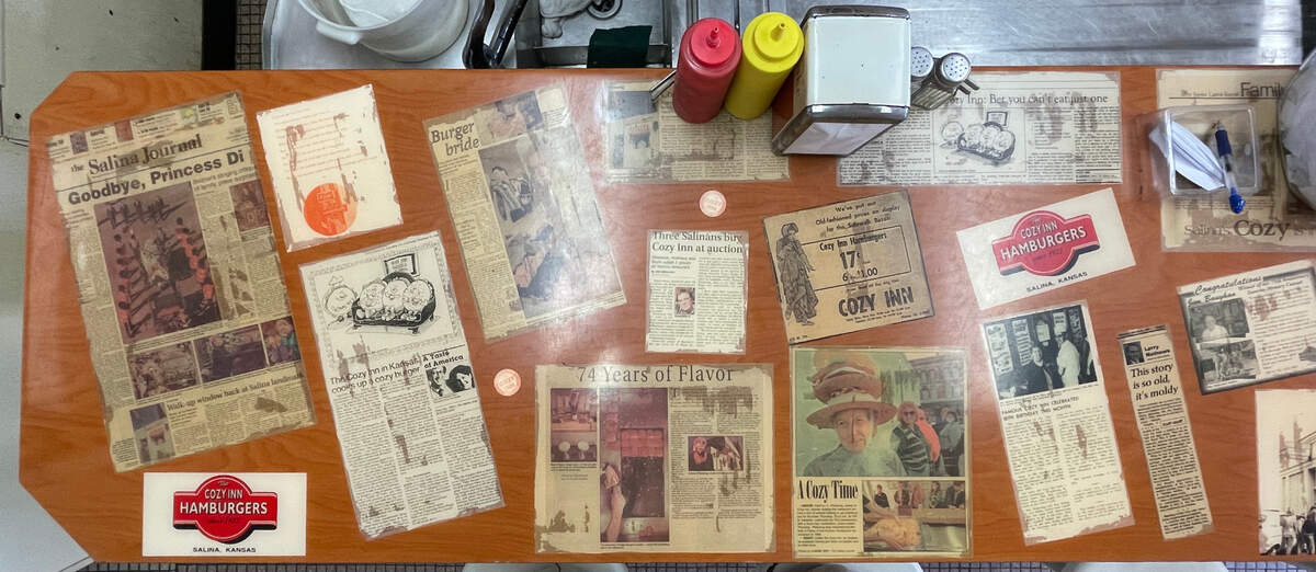 News clippings about The Cozy Inn from over the decades are plastered on the Salina restaurant’s counter.