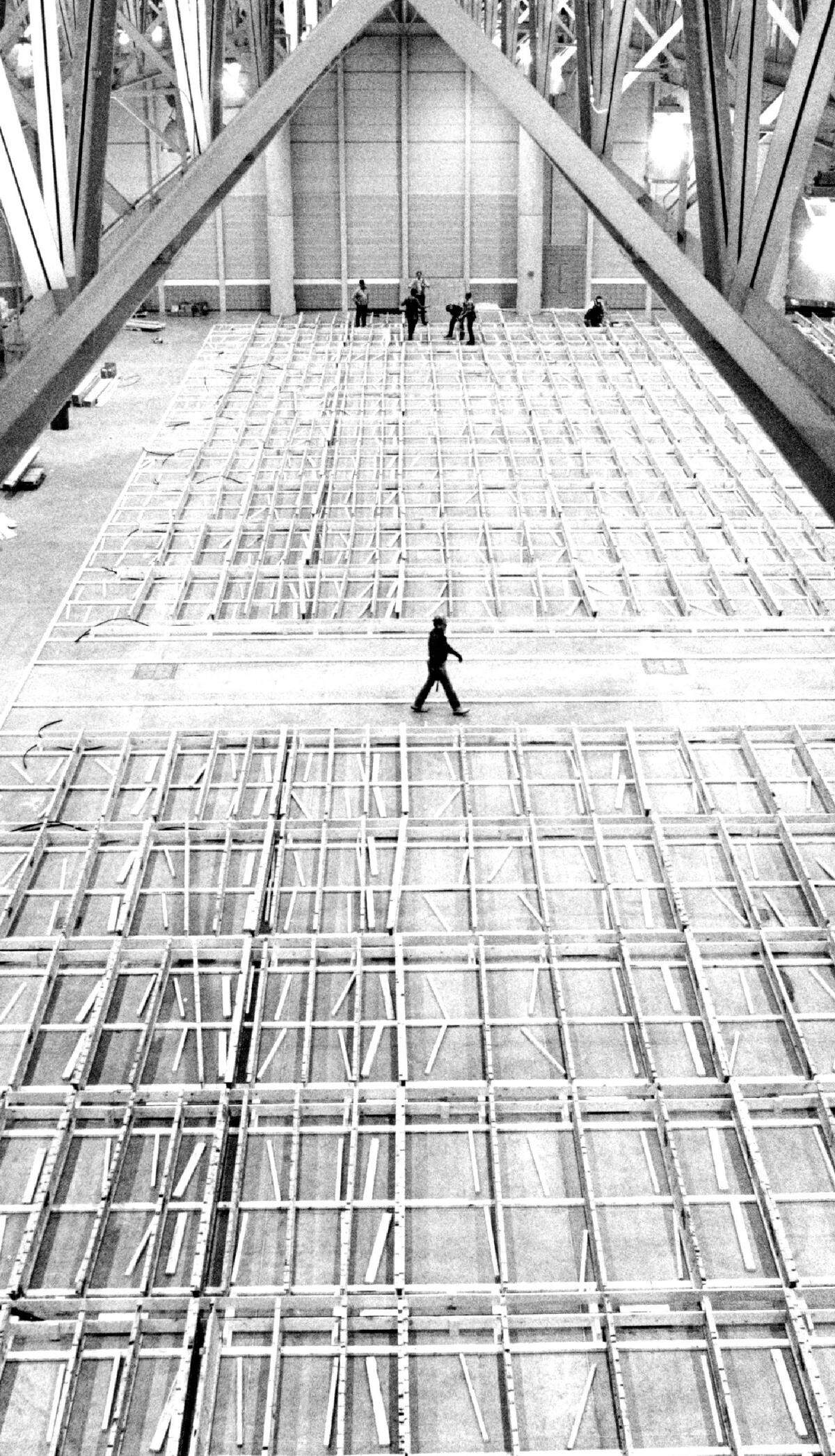 The framework for bowling lanes covers a portion of the Bob Brown Expo Hall as workers prepare the lanes for use at the American Bowling Congress Tournament in 1989.