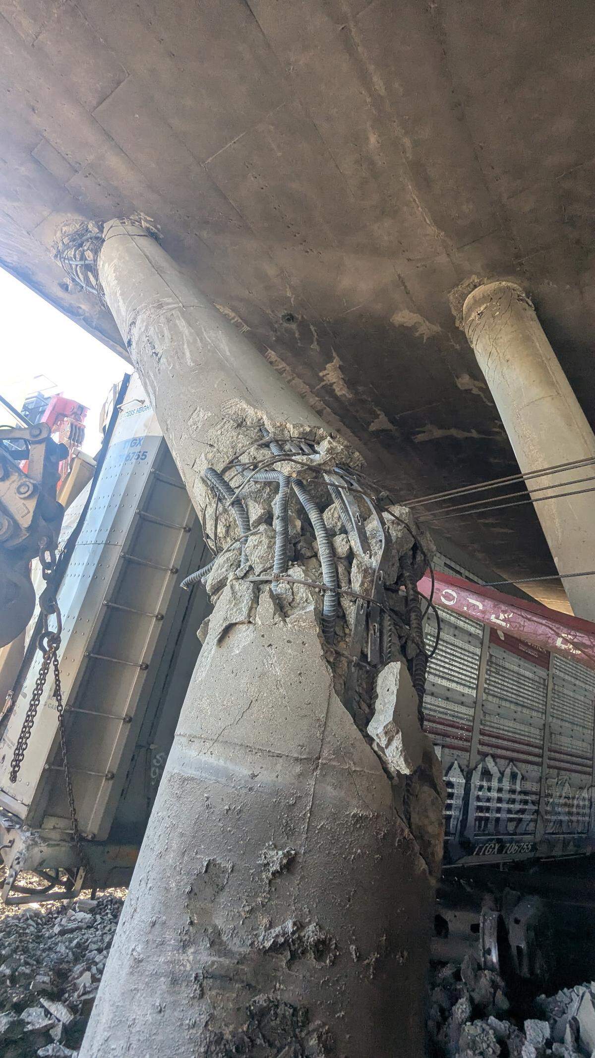 A bridge support column at under northbound I-135 shows damage linked to an overnight Union Pacific derailment on March 20.