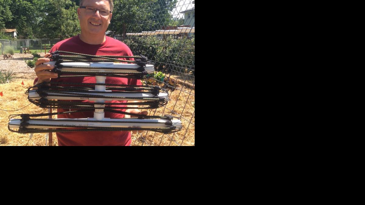 Everett Price organizes three sizes of bungee cords on PVC pipes that he glued together.

