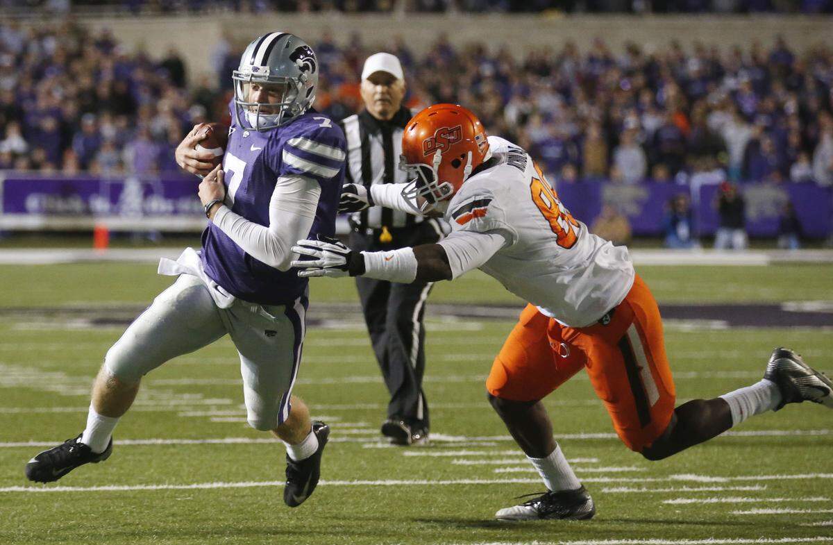 Kansas State Wildcats quarterback Collin Klein, left, scrambles during a game against Oklahoma State on Nov. 3, 2012.