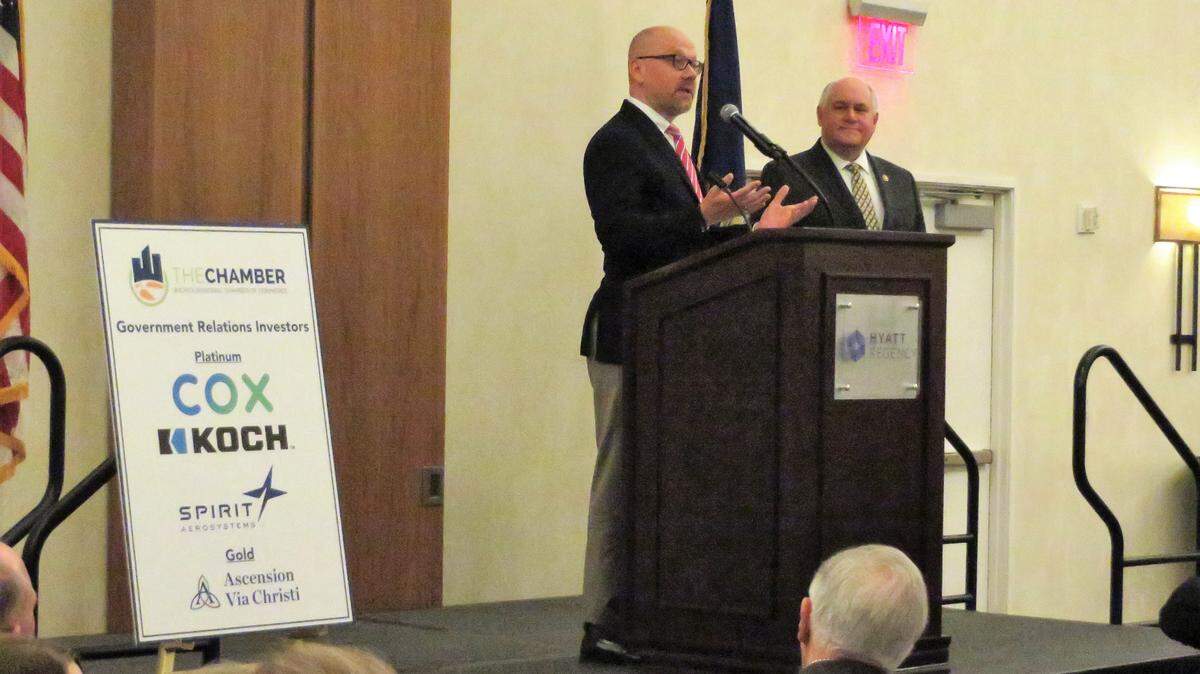 At a lunch meeting of the Wichita Regional Chamber of Commers, Rep. Ron Estes, right, receives a “Spirit of Enterprise” award from Ron Eidshaug, a vice president and lobbyist for the U.S. Chamber of Commerce.