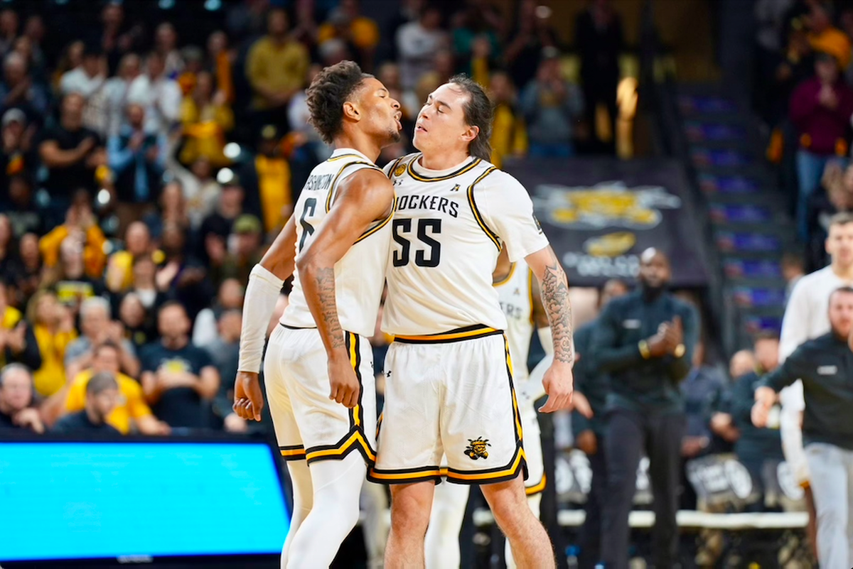 Corey Washington and Bijan Cortes celebrate after connecting on an alley-oop score in the first half of Wichita State’s home win over Montana State at Koch Arena on Saturday.