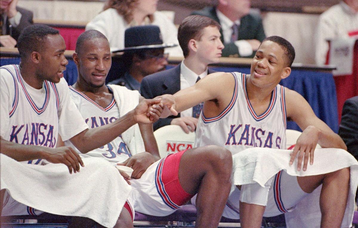 KU’s Steve Woodberry, right, congratulates teammates Jacque Vaughn, left, and Richard Scott towards the end of game against Tennessee Chattanooga in 1994.