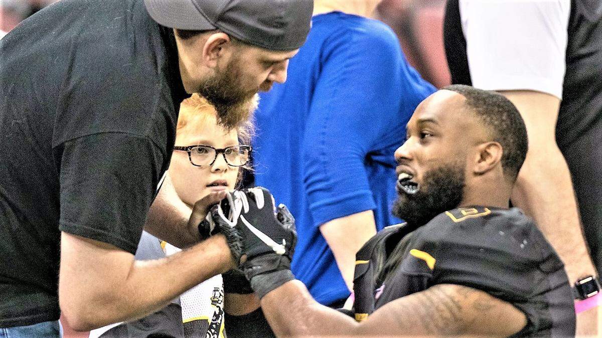 Running back Mikhail Lindsay shares a moment with fans at a Wichita Force indoor football game. The team has announced it’s moving for the 2020 season from Intrust Bank Arena in Wichita to the Hartman Arena in Park City.