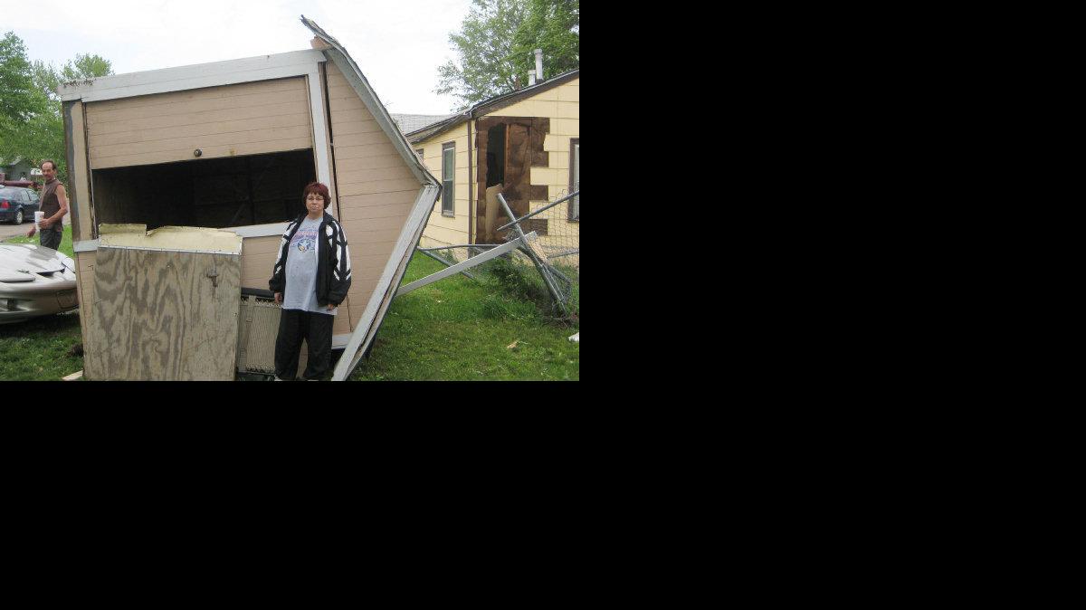 Rose Anne Bura stands by her backyard shed that was flipped over her Oaklawn house to the front yard by the tornado.