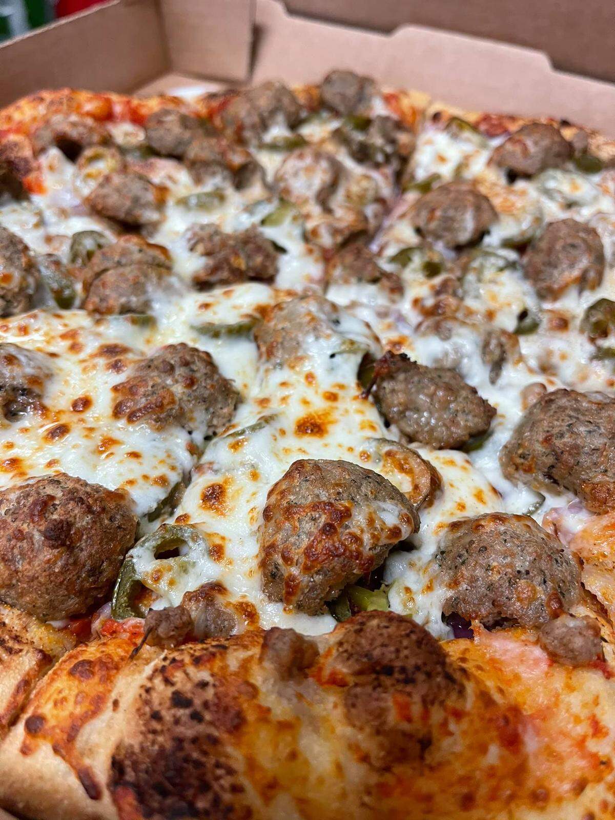 Electric Pizzeria’s pizzas are made on New York-style crust that’s think in the middle with a thick crust on the edges.