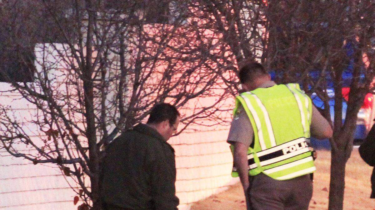 Wichita Police officers look at one of the 2 motorcycles involved in a fatal crash in December 2013.