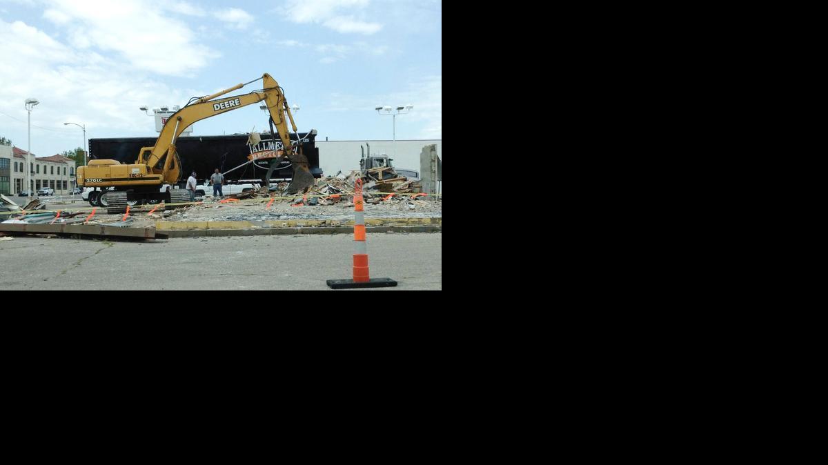 A crew works on a former car lot at Hydraulic and Douglas to make room for a parking lot for McGinty Machine. The lot and adjacent facility were once owned by Big Dog Motorcycles. 

