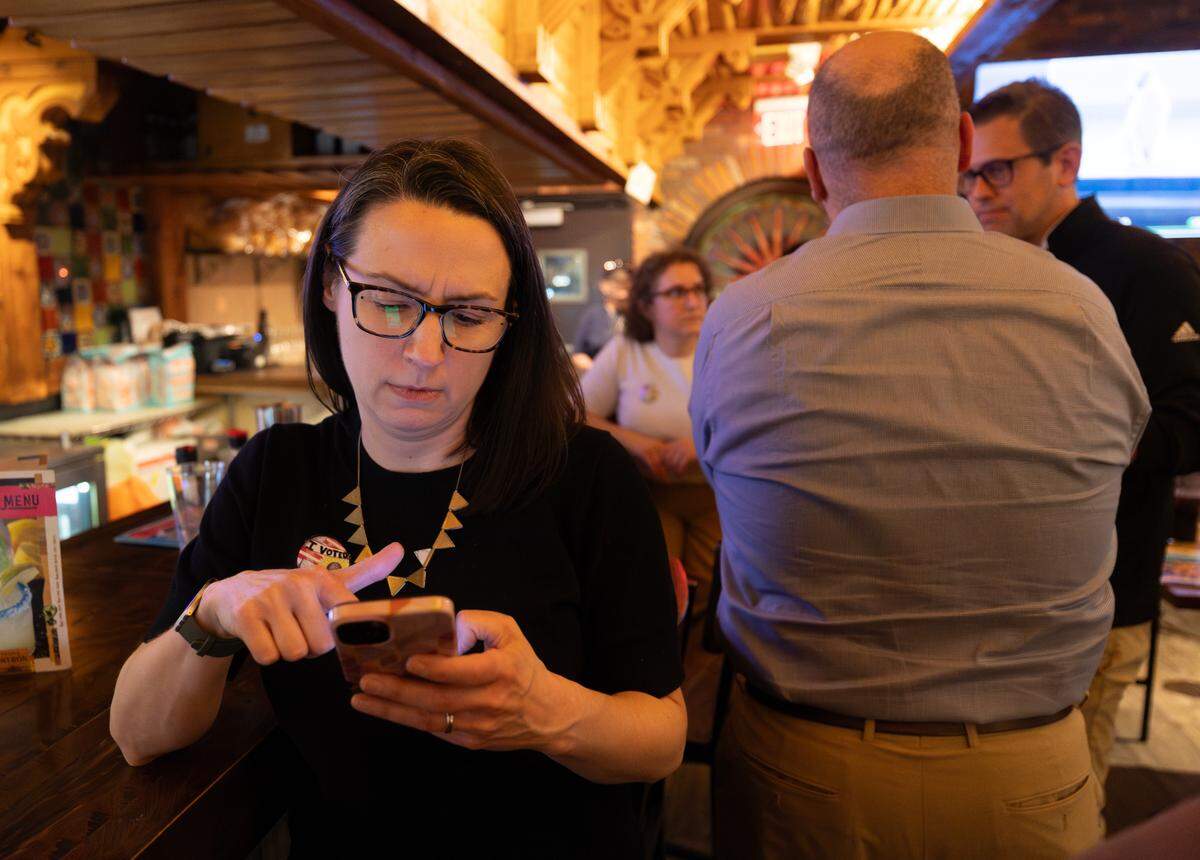 Jennifer Szambecki of the Vote Yes coalition looks at election results on her phone at Carlos O’Kelly’s at Maple and Ridge on Tuesday night.