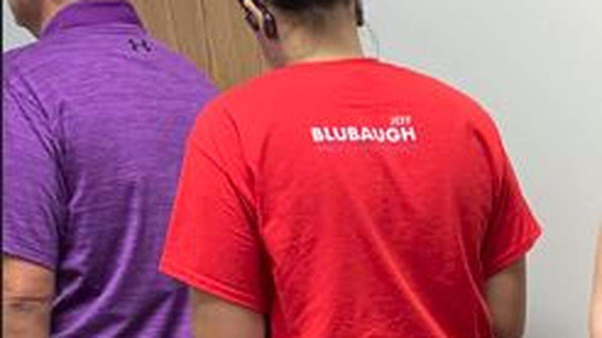 An Eagle reader shot this picture of Meghan Blubaugh in line to vote with her husband, Jeff, a candidate for Sedgwick County Commission. State law bans wearing or distributing anything that identifies a candidate within 250 feet of a polling place.