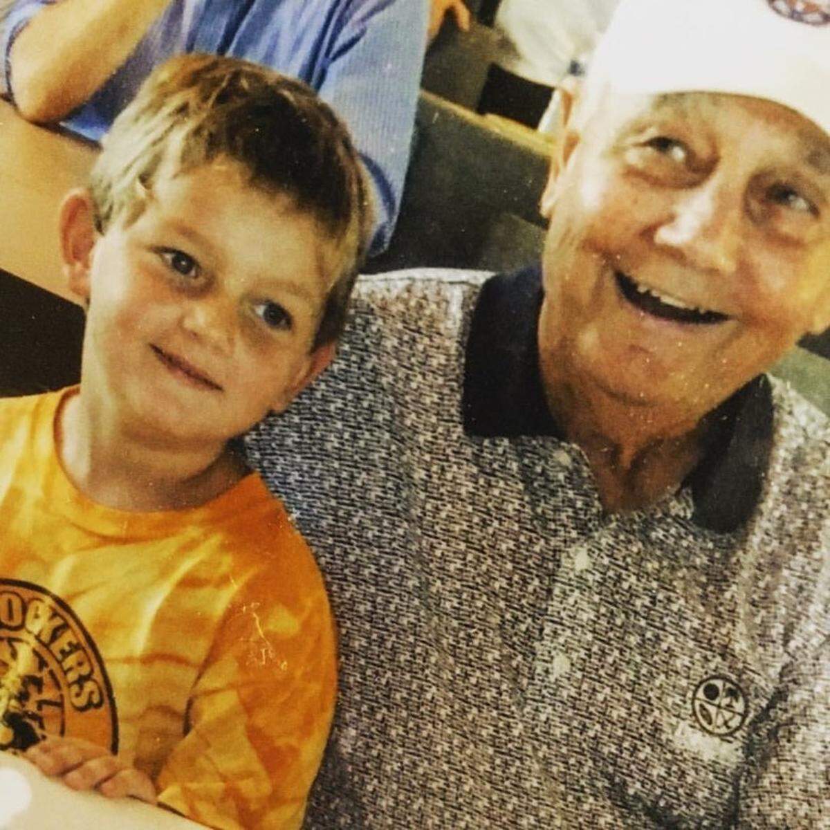 Ed Kriwiel, legendary Kapaun Mt. Carmel football coach, sits with his grandson, Clay Cundiff.