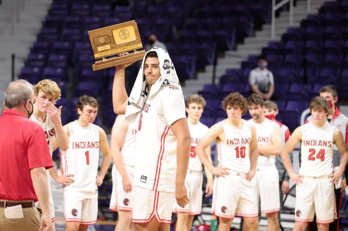 Harlan Obioha holds up the third place award after leading Hoxie to a third-place trophy in the Class 2A state tournament in 2021.