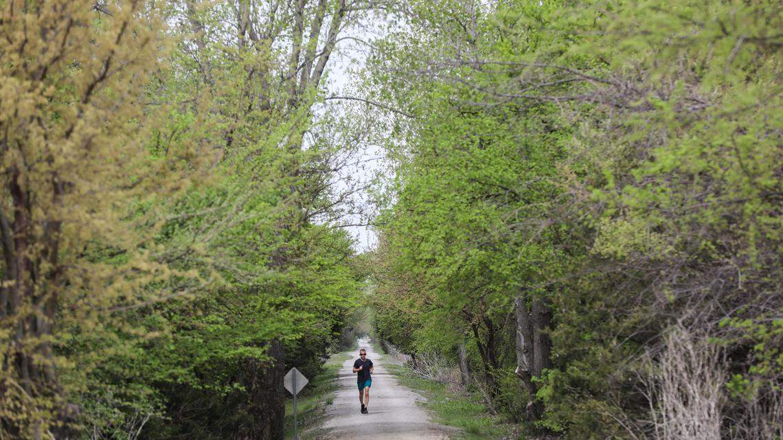 A runner exercises near 135th St. W and the Prairie Sunset Trail. The city plans to expand the path from downtown Wichita to Garden Plain. (April 26, 2021)