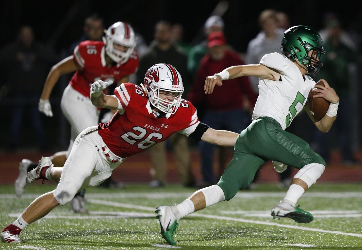 Maize defender #26 Carson Shively can’t quite catch Derby quarterback Hunter Igo. (October 19, 2018)