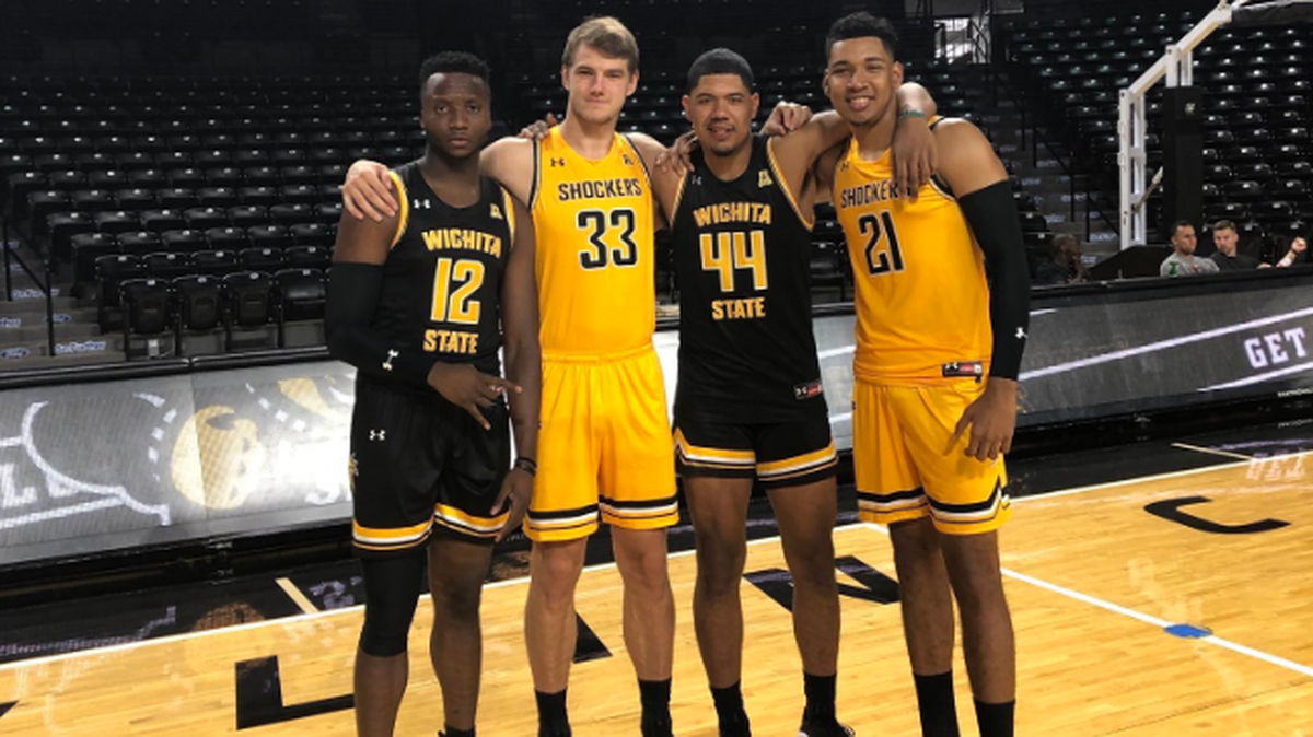 Wichita State’s Morris Udeze, Asbjorn Midtgaard, Isaiah Poor Bear Chandler and Jaime Echenique show off Wichita State’s new black and yellow jerseys made by Under Armour that the team will wear for the 2018-19 season.