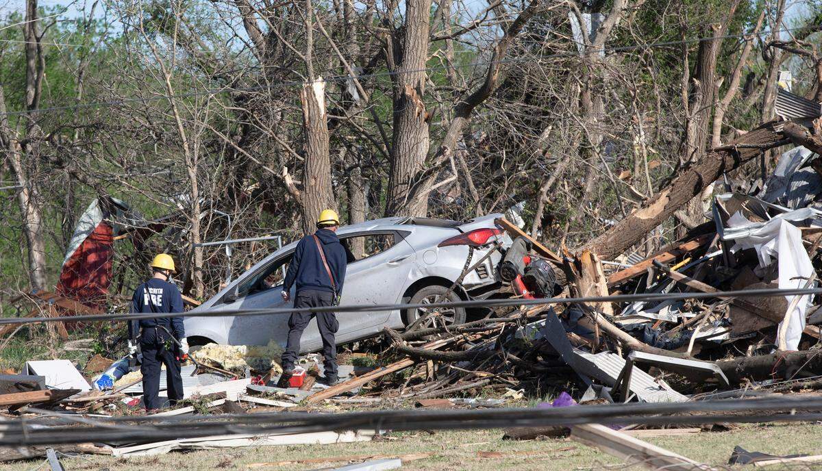 Wichita firefighters search what’s left of John’s Animal World after a tornado hit it on April 29, 2022. This building is directly north of the Andover YMCA. (April 30, 2022)