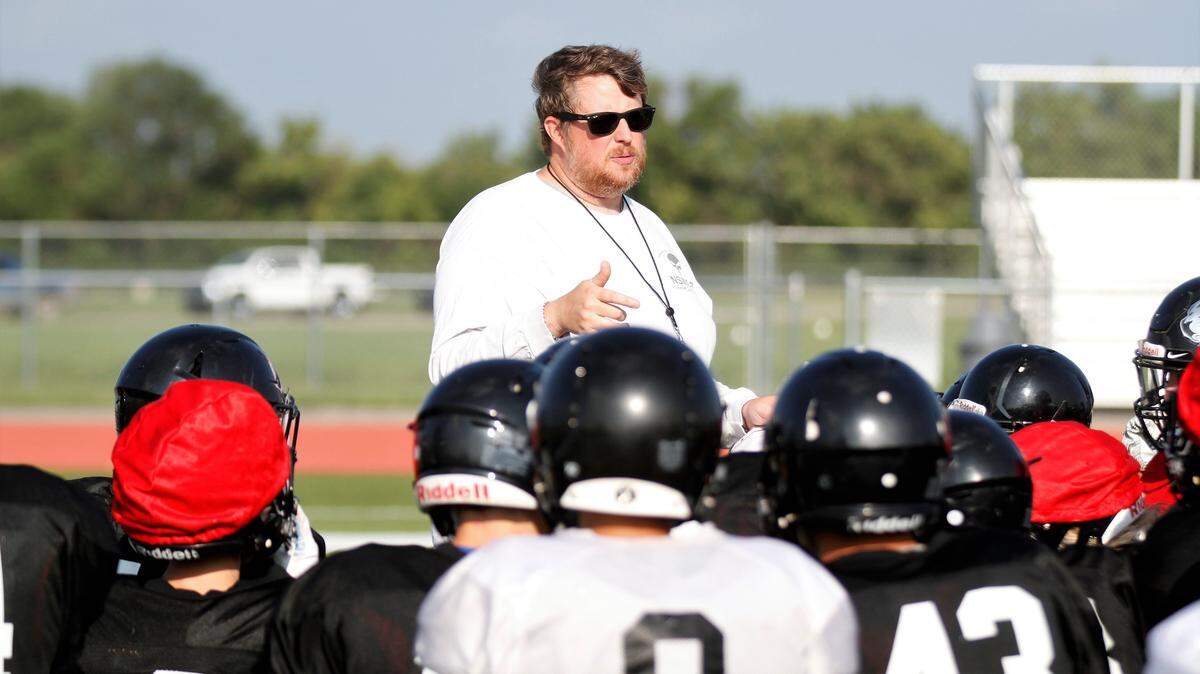 Eisenhower football coach Marc Marinelli talks with his team after a fall practice. Marinelli resigned as coach of the Tigers after their 20-7 playoff loss to Salina Central on Friday.