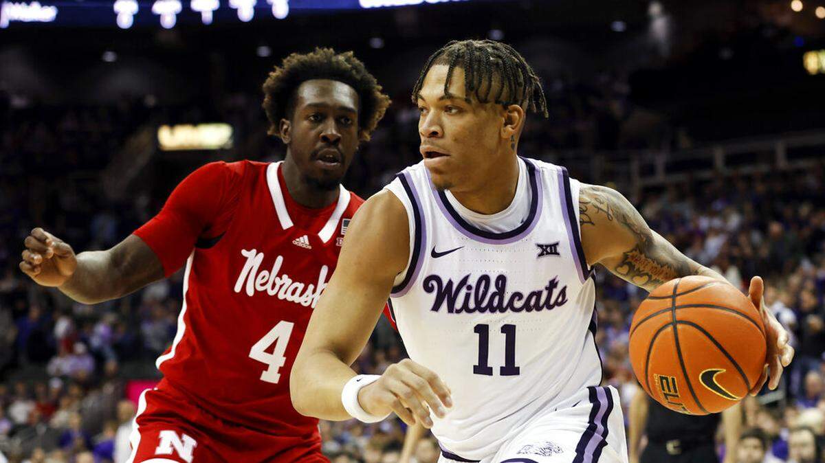 Kansas State forward Keyontae Johnson (11) drives to the basket as Nebraska forward Juwan Gary (4) defends during the first half of an NCAA college basketball game, Saturday, Dec. 17, 2022, in Kansas City, Mo. (AP Photo/Colin E. Braley)