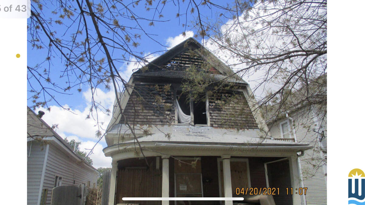 A photo from a city presentation on “repair and removal of dangerous and unsafe structures.” The concept of a land bank is to acquire distressed houses and get them into the hands of local nonprofit groups that can repair or replace them, such as Habitat for Humanity or Mennonite Housing.