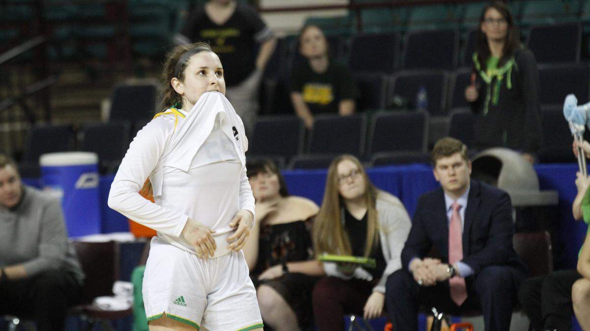 Bishop Carroll's Allison McFarren bites her jersey after the Eagles' 54-40 loss to St. Thomas Aquinas in the Class 5A state championship game Saturday at the Kansas Expocentre in Topeka.