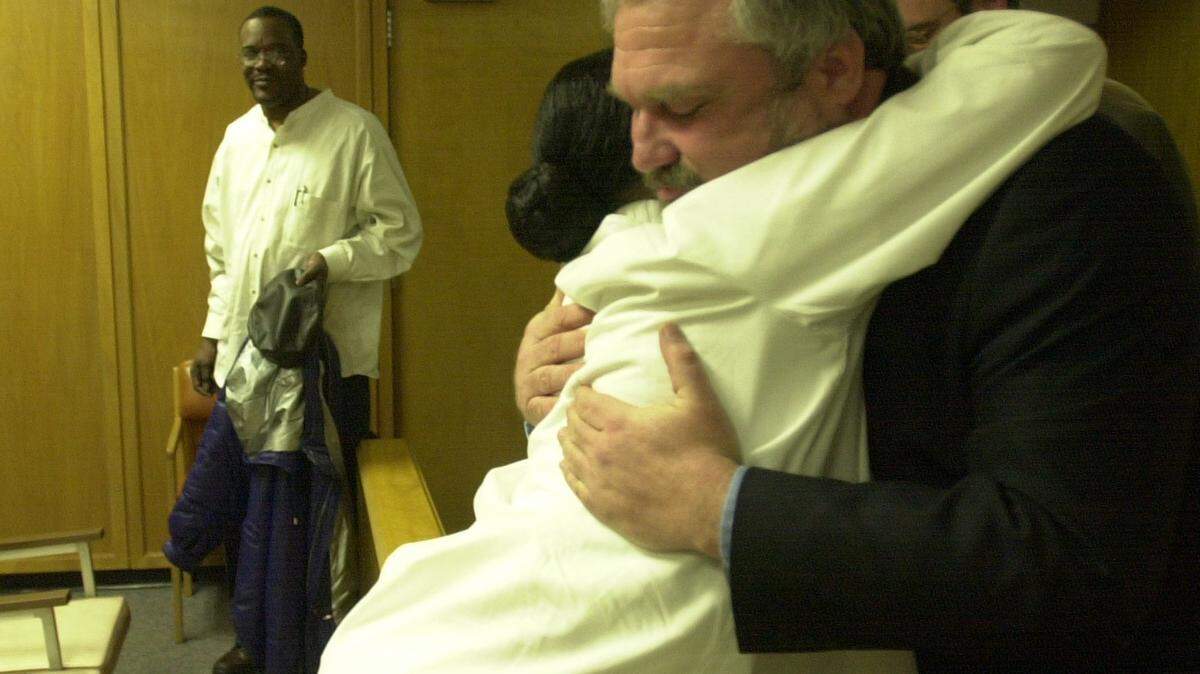 Martha Darby hugs defense attorney Richard Ney after he helped her son, Earl Bell II, get acquitted on four counts of first degree murder in 2002.